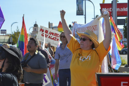 SUUS Member raises a clenched fist for LGBTQ acceptance